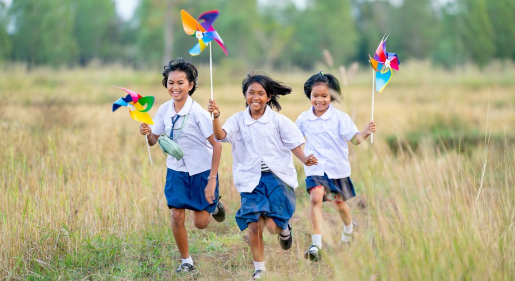 Asian girls hold small windmill